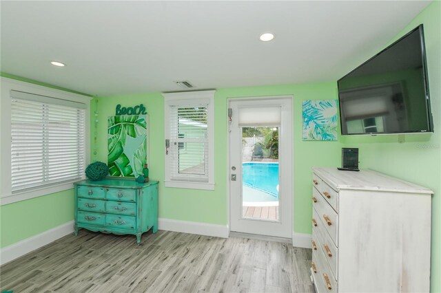 205 Elm Ave, Anna Maria, FL 34216 - doorway to outside with visible vents, recessed lighting, light wood finished floors, and baseboards