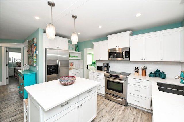 205 Elm Ave, Anna Maria, FL 34216 - kitchen featuring a healthy amount of sunlight, stainless steel appliances, open shelves, and a sink