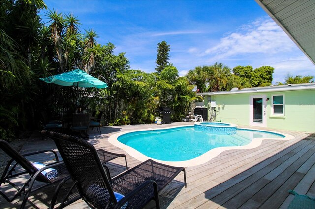 205 Elm Ave, Anna Maria, FL 34216 - view of swimming pool featuring a deck, a patio, and a pool with connected hot tub