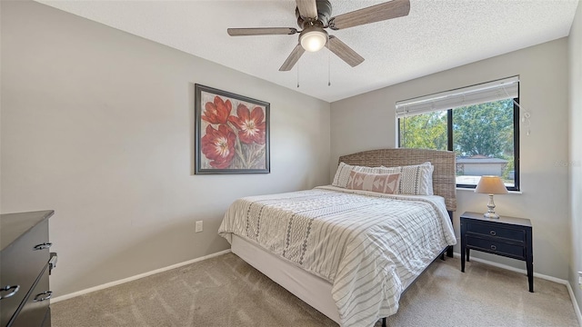 bedroom featuring light colored carpet, a ceiling fan, and baseboards