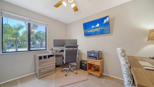 office with baseboards, ceiling fan, and light carpet