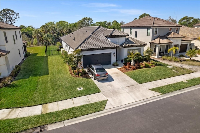 mediterranean / spanish-style house featuring concrete driveway, a tiled roof, an attached garage, stucco siding, and a front lawn