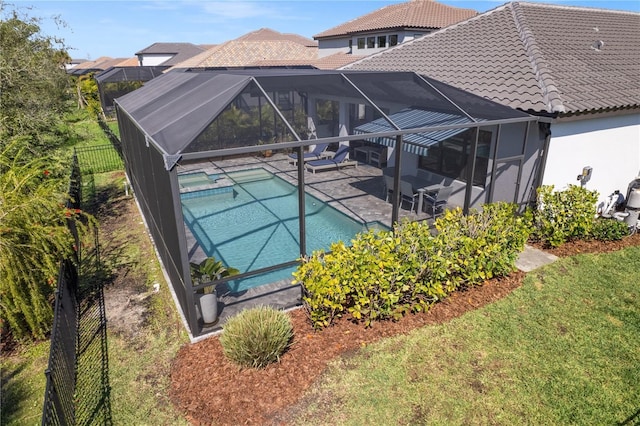 pool with a patio, fence, and a lanai