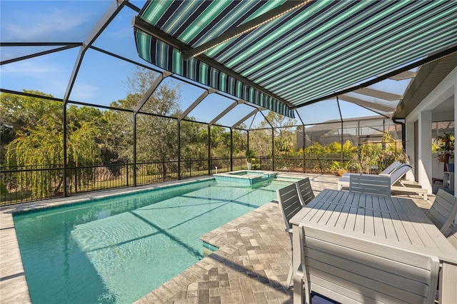 view of swimming pool with glass enclosure, a pool with connected hot tub, and a patio area
