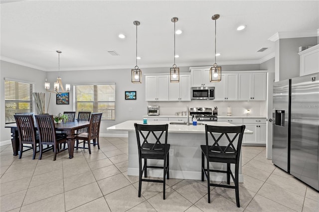 kitchen with light tile patterned floors, a healthy amount of sunlight, stainless steel appliances, and baseboards