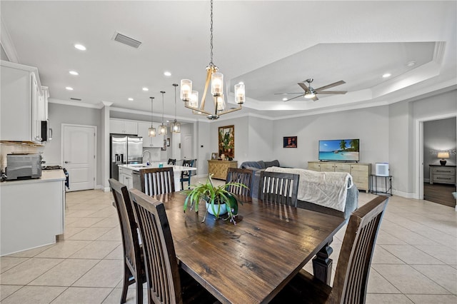dining space with light tile patterned floors, recessed lighting, ornamental molding, and ceiling fan with notable chandelier