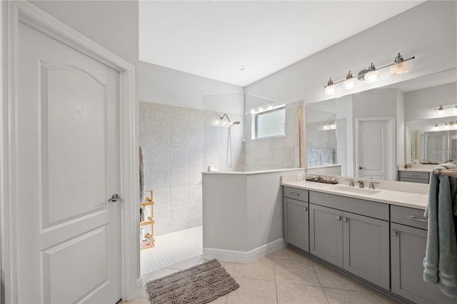 bathroom featuring a walk in shower, tile patterned flooring, and vanity