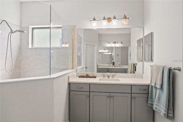 full bathroom featuring walk in shower and vanity