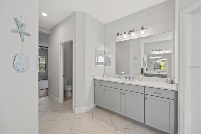 bathroom with recessed lighting, vanity, tile patterned floors, toilet, and baseboards