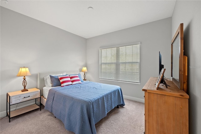 carpeted bedroom featuring baseboards