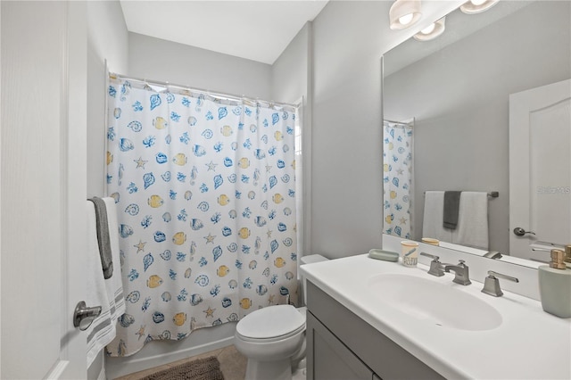 bathroom featuring toilet, shower / tub combo, and vanity