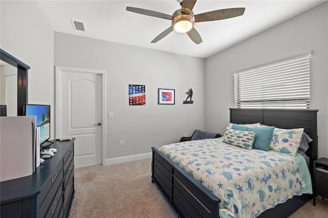 bedroom with visible vents, ceiling fan, light carpet, and baseboards