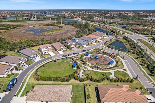 drone / aerial view featuring a residential view and a water view