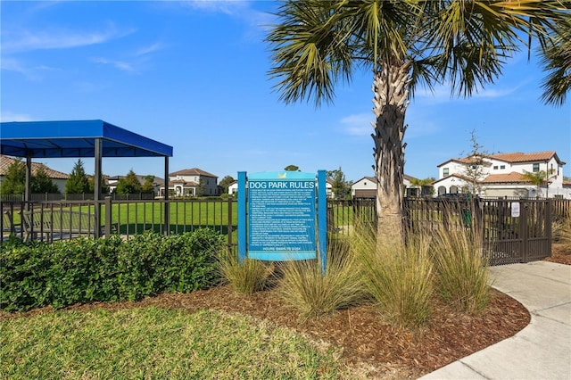 view of home's community with a residential view, a lawn, and fence