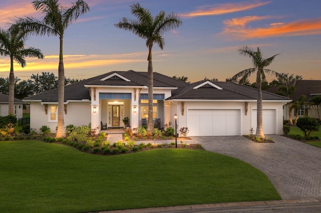 14210 9th Ter NE, Bradenton, FL 34212 - view of front of home with an attached garage, stucco siding, decorative driveway, a front yard, and a tiled roof