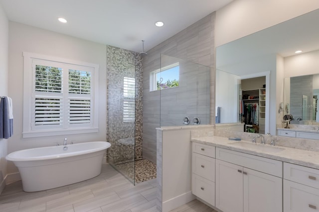 14210 9th Ter NE, Bradenton, FL 34212 - full bath with plenty of natural light, walk in shower, vanity, a soaking tub, and recessed lighting