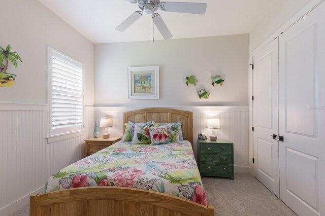 14210 9th Ter NE, Bradenton, FL 34212 - bedroom featuring wainscoting, light carpet, ceiling fan, and a closet