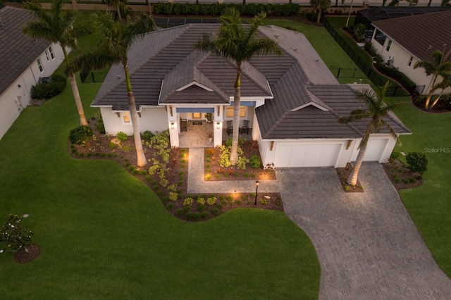 14210 9th Ter NE, Bradenton, FL 34212 - view of front of home with a garage, driveway, a tiled roof, a front yard, and stucco siding
