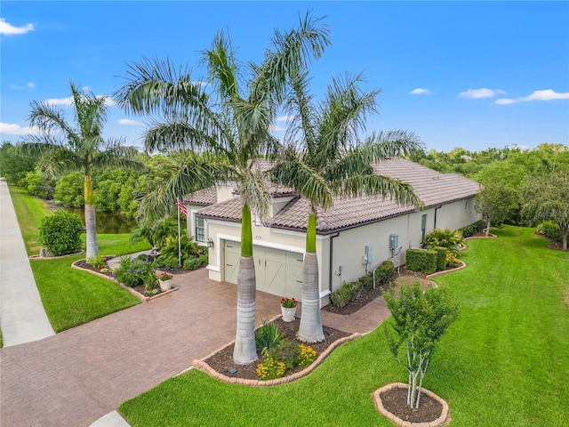 view of property exterior featuring a garage, decorative driveway, stucco siding, and a yard