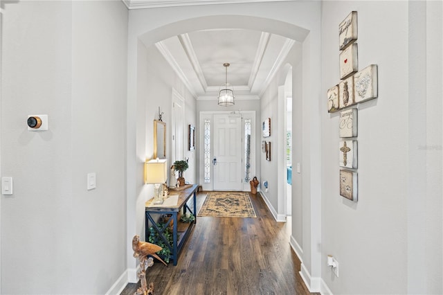 entryway featuring baseboards, arched walkways, dark wood-style flooring, and crown molding