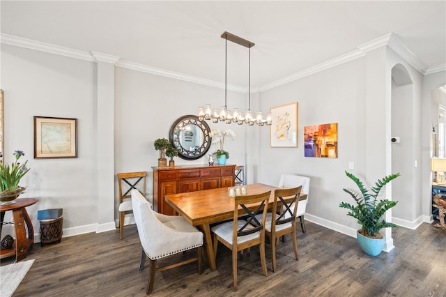 dining space featuring crown molding, arched walkways, baseboards, and dark wood finished floors