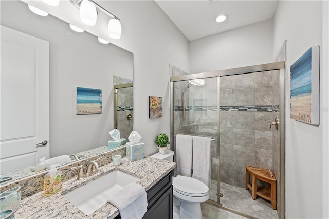full bathroom with vanity, a stall shower, and toilet