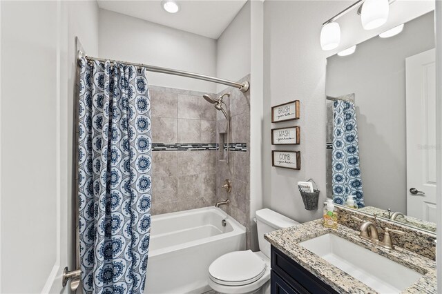 full bathroom featuring vanity, shower / tub combo with curtain, and toilet