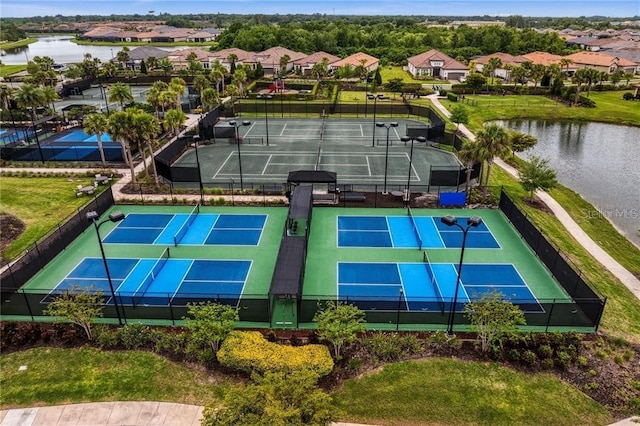 birds eye view of property featuring a water view and a residential view