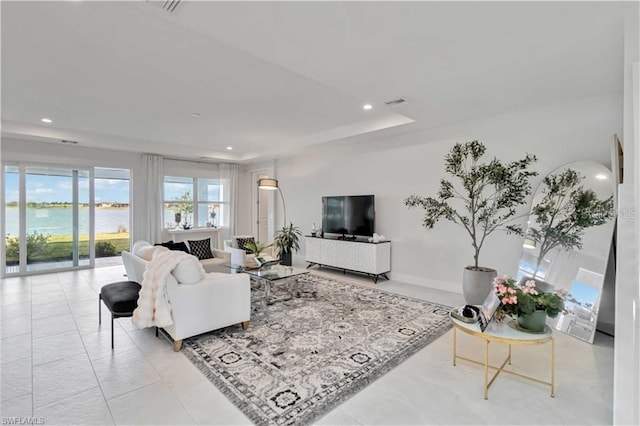 living area with visible vents, recessed lighting, and a water view