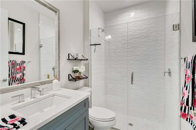 full bath with toilet, a shower stall, and vanity