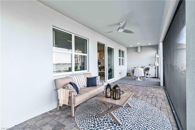 sunroom featuring outdoor lounge area and ceiling fan