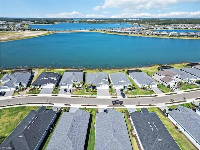 bird's eye view featuring a water view and a residential view