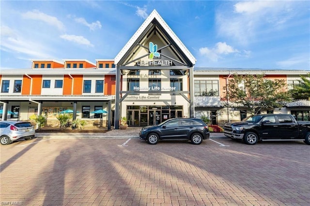 view of building exterior with uncovered parking