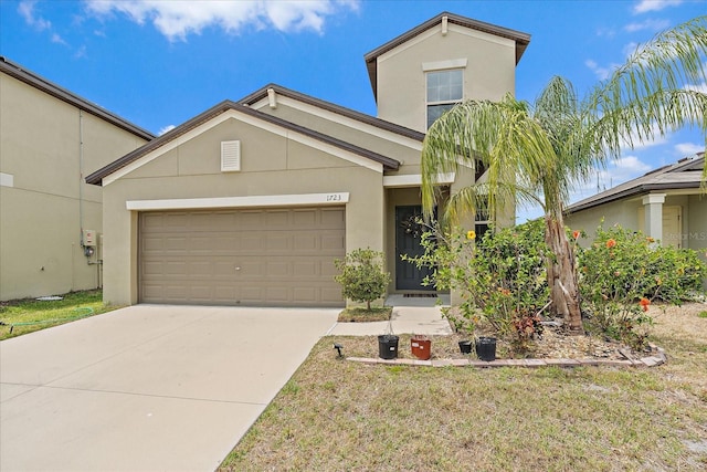 1723 Fred Ives St, Ruskin, FL 33570 - view of front facade featuring concrete driveway, stucco siding, and a garage