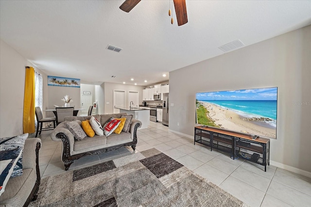 1723 Fred Ives St, Ruskin, FL 33570 - living area featuring light tile patterned floors, visible vents, baseboards, and a ceiling fan