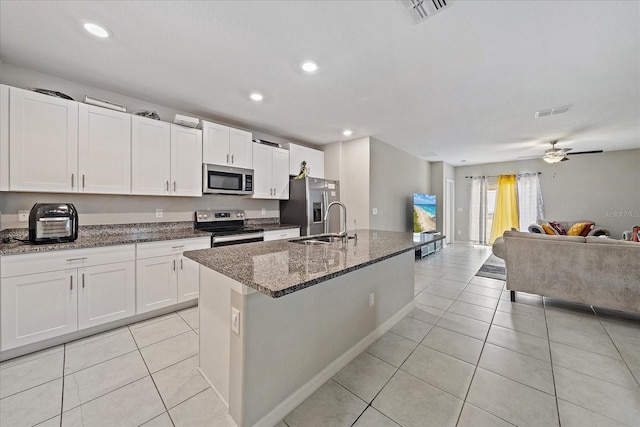 1723 Fred Ives St, Ruskin, FL 33570 - kitchen with light tile patterned floors, stainless steel appliances, open floor plan, and visible vents