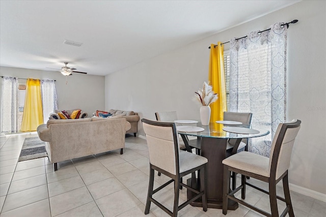 1723 Fred Ives St, Ruskin, FL 33570 - dining room featuring light tile patterned floors, visible vents, baseboards, and a ceiling fan