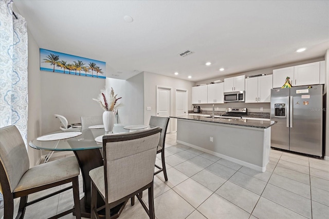 1723 Fred Ives St, Ruskin, FL 33570 - dining area with light tile patterned floors, visible vents, baseboards, and recessed lighting