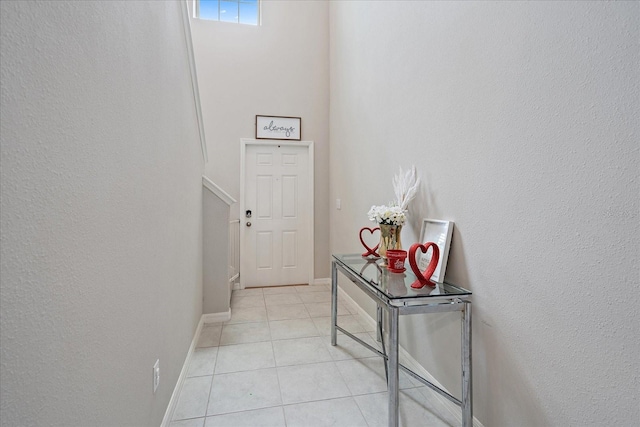 1723 Fred Ives St, Ruskin, FL 33570 - corridor with baseboards, light tile patterned flooring, and a textured wall