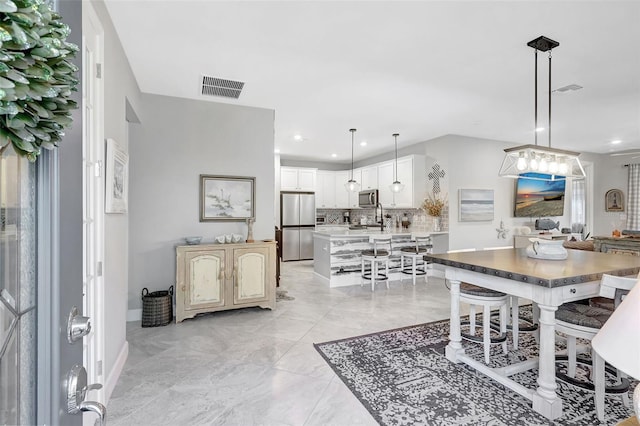 12291 Myrtle Bay Ct, Sarasota, FL 34238 - dining space featuring recessed lighting and light marble finish flooring