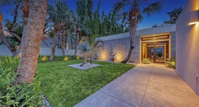 view of yard with french doors and fence
