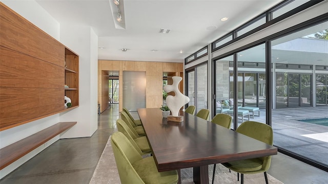 dining room with finished concrete flooring, visible vents, and recessed lighting