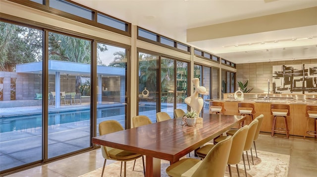sunroom / solarium featuring a sink