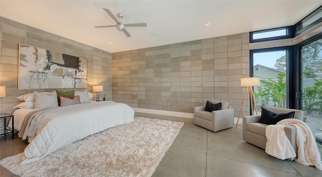 bedroom with recessed lighting, tile walls, ceiling fan, and concrete flooring