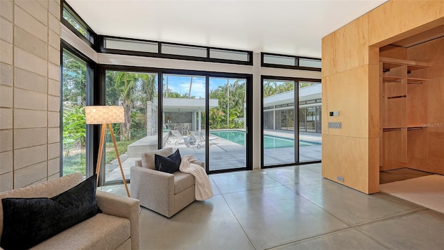 doorway featuring finished concrete flooring and expansive windows