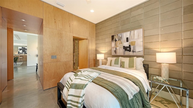 bedroom with finished concrete flooring, visible vents, and recessed lighting