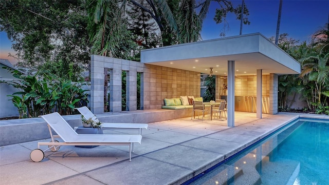pool featuring a patio and an outdoor living space