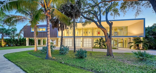 4123 Bay Shore Rd, Sarasota, FL 34234 - view of front of house with driveway, a carport, an attached garage, and a front yard