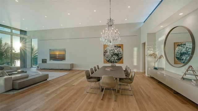 4123 Bay Shore Rd, Sarasota, FL 34234 - dining area with a chandelier, light wood finished floors, a towering ceiling, recessed lighting, and a wall of windows