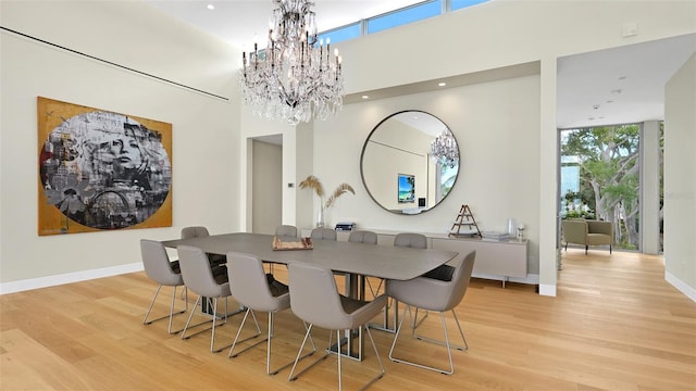 4123 Bay Shore Rd, Sarasota, FL 34234 - dining area featuring a chandelier, wood finished floors, baseboards, recessed lighting, and floor to ceiling windows